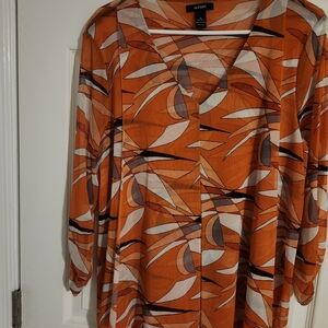 An Alfani elegant blouse in orange with white and black.